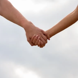 Two hands holding each other