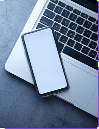 A phone sitting on a open laptop